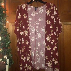 Sleeveless, red floral cardigan.